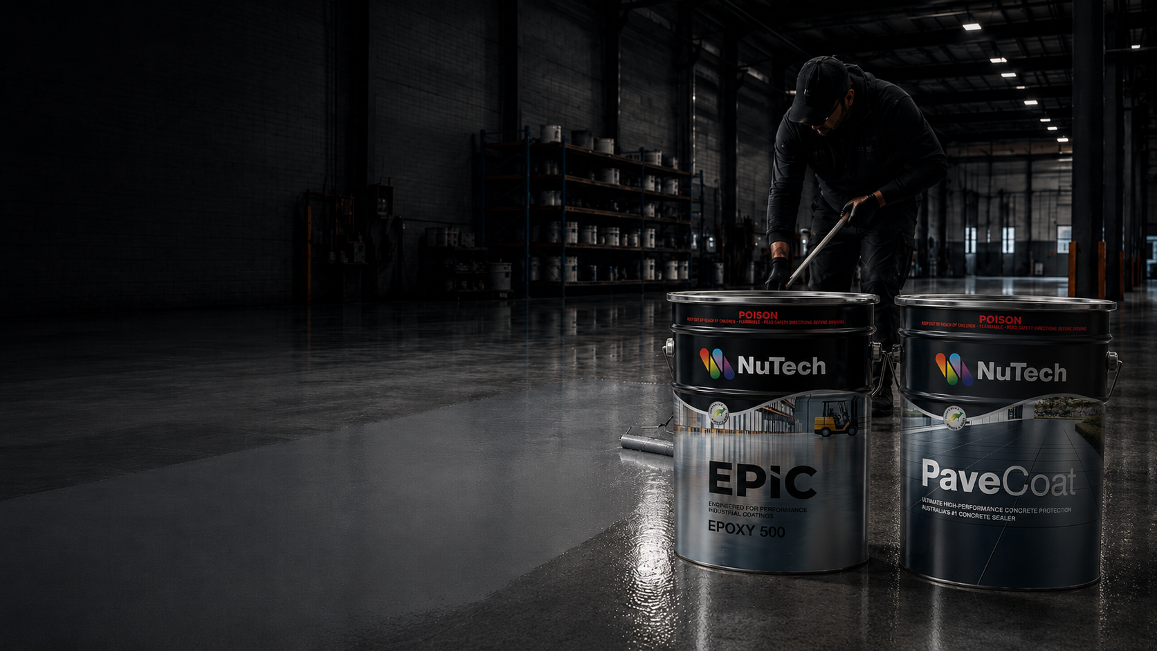Applicator rolling NuTech epoxy coating across a warehouse floor