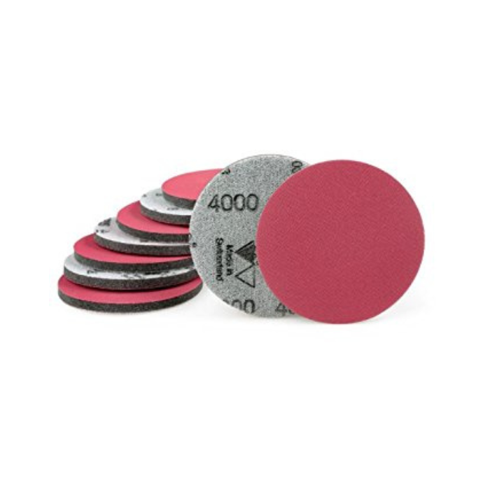 Set of sanding discs with pink and gray colors on a white background